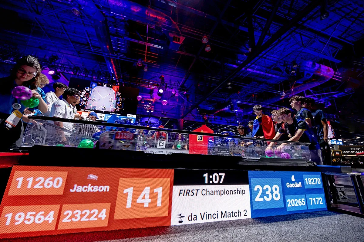 A FIRST Tech Challenge match in progress at the FIRST Championship, drivers at the field with the score on the screen
