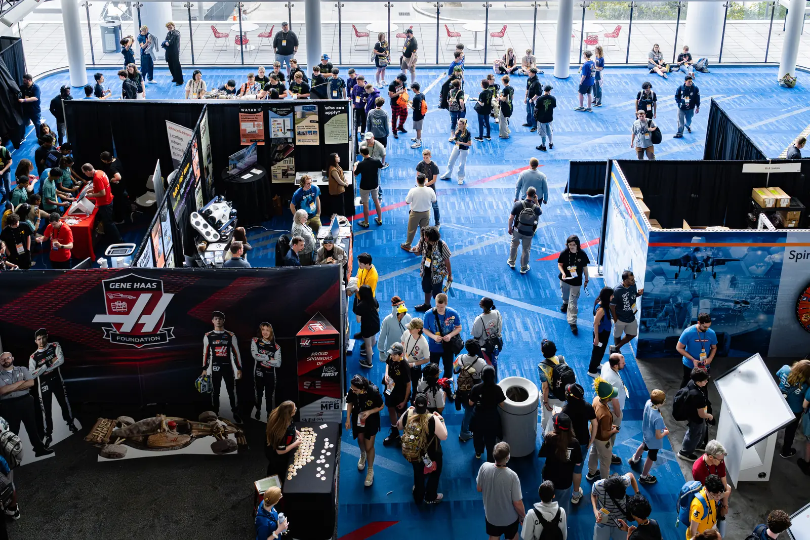 The pit and exhibition hall at the FIRST Championship, crowded with teams and sponsor booths